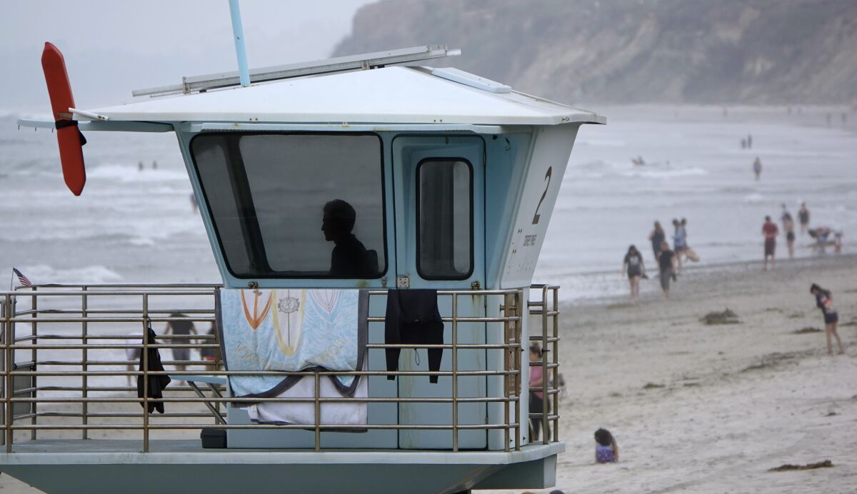 A state lifeguard looks over Torrey Pines State Beach on Monday. 
