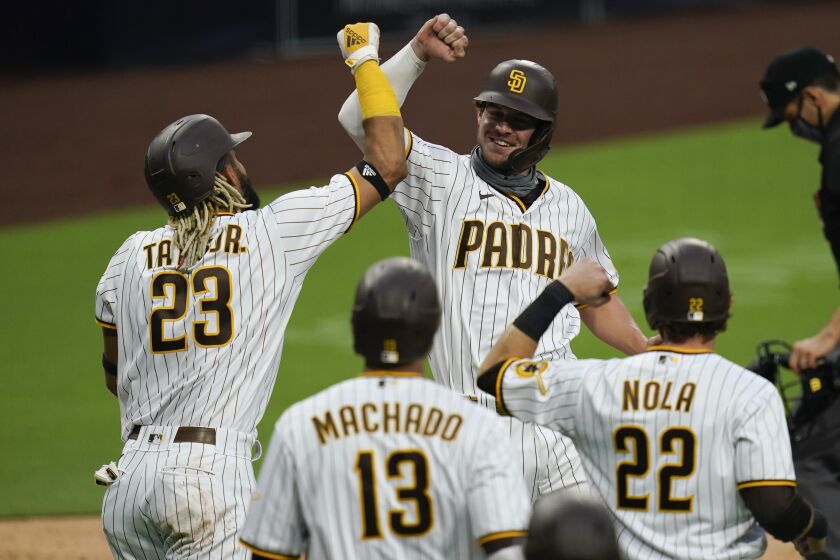 San Diego Padres' Wil Myers, facing camera, celebrates with teammates after hitting a grand slam.