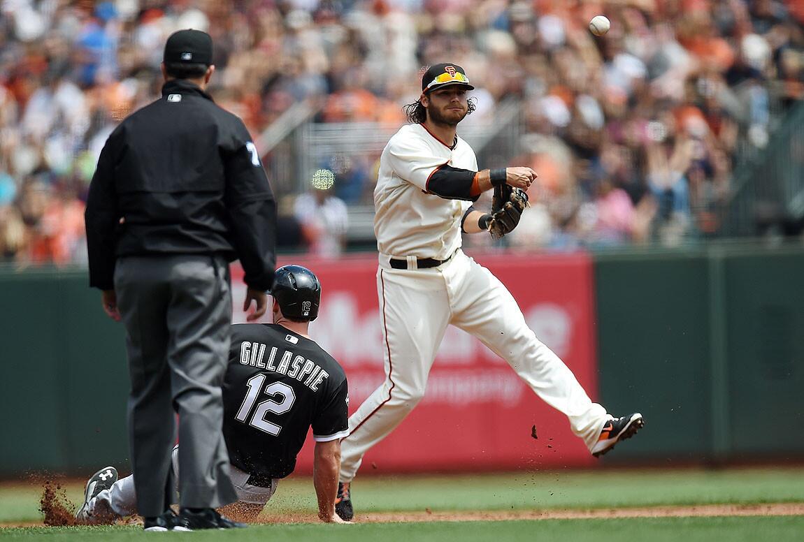 San Francisco's Brandon Crawford completes a double play as Conor Gillaspie slides.