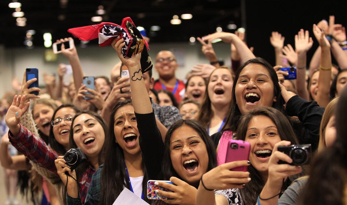 Fans cheer as their favorite YouTube stars from Our2ndLife arrive for their photo and autograph session during the three-day VidCon convention at the Anaheim Convention Center on Friday, June 27, 2014.