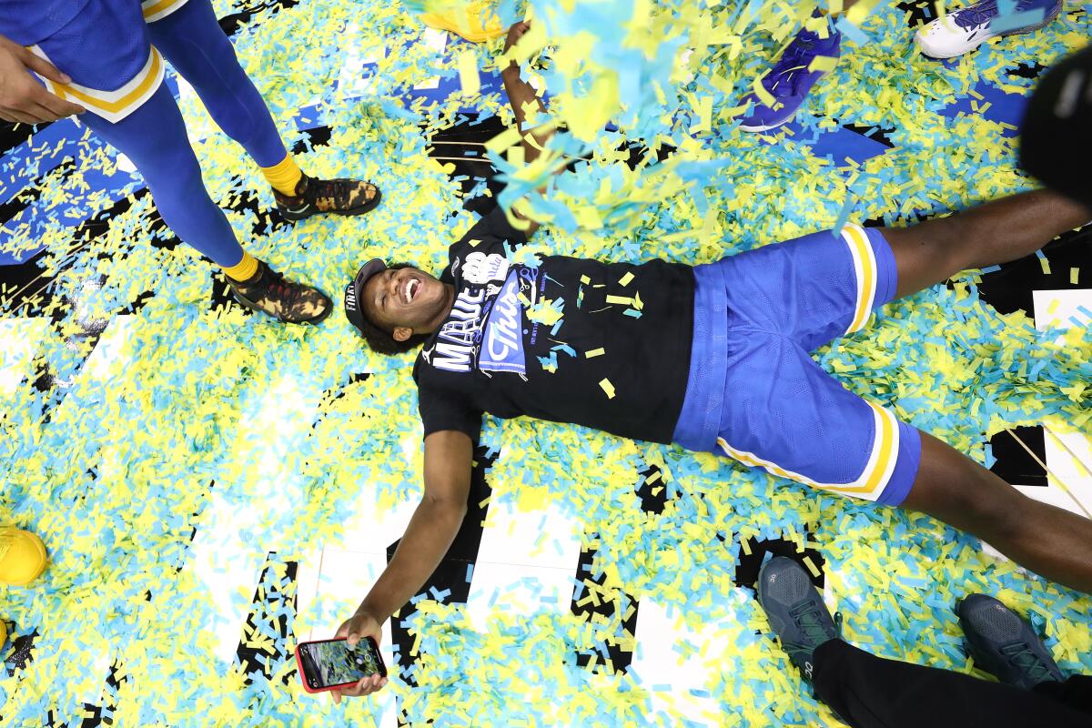 UCLA's David Singleton celebrates after the Bruins defeated Michigan in the Elite Eight on March 30, 2021, in Indianapolis.