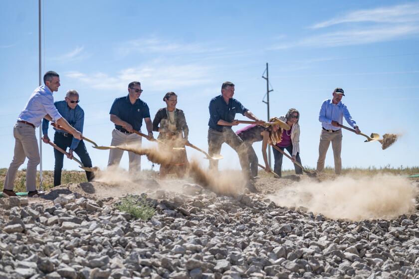 FILE - Dignitaries, including U.S. Secretary of the Interior Deb Haaland, center, break ground on the new SunZia transmission line project, Sept. 1, 2023, in Corona, N.M. A federal judge on Tuesday, April 16, 2024, rejected a request by Native American tribes and environmentalists to stop work on the $10 billion transmission line being built through a remote southeastern Arizona valley that will carry wind-generated electricity from New Mexico to customers as far away as California. (Jon Austria/The Albuquerque Journal via AP, File)