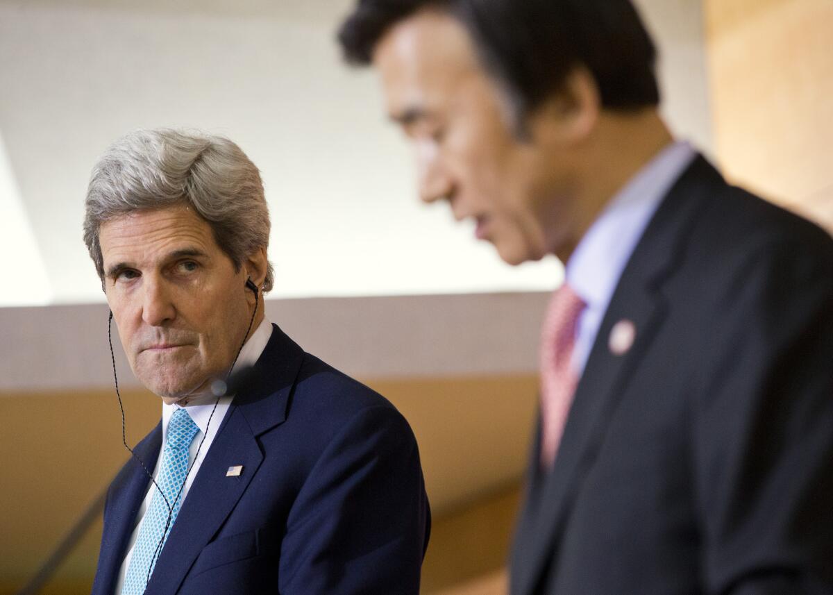 U.S. Secretary of State John F. Kerry, left, looks on as South Korean Foreign Minister Yun Byung-se delivers a statement in Seoul.