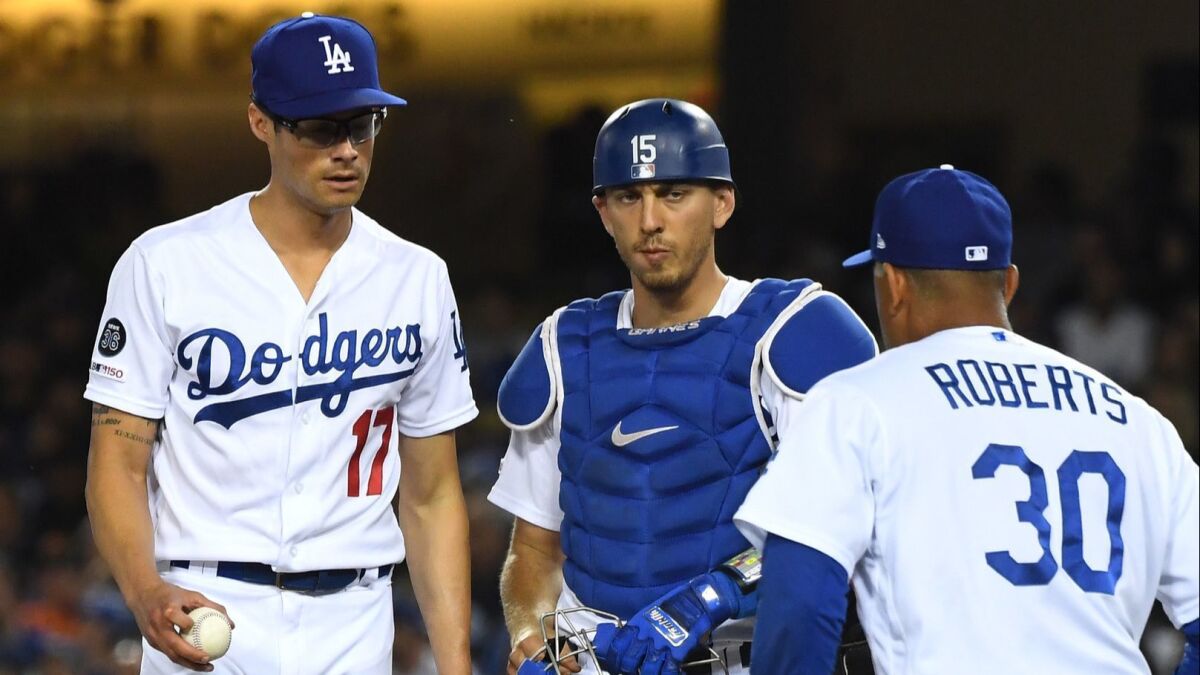 Dodgers manager Dave Roberts joins catcher Austin Barnes and Joe Kelly on the mound during a game against San Francisco on April 2. Kelly was pulled from the game.