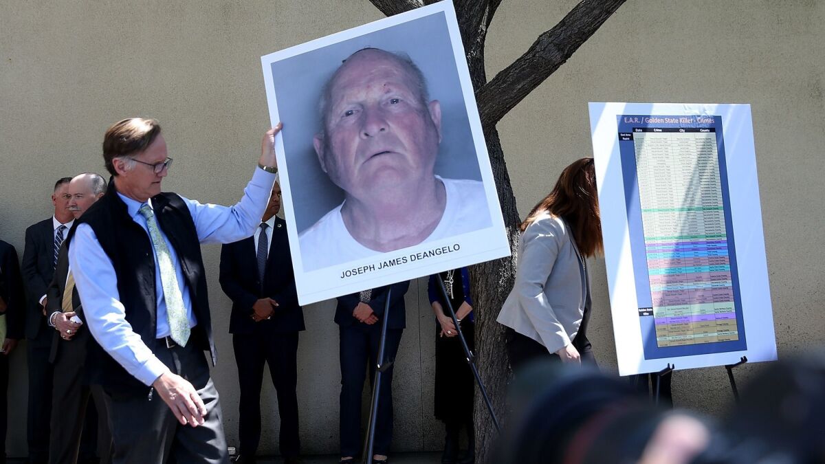 A photo of Joseph James DeAngelo Jr. is displayed during a news conference announcing his arrest.