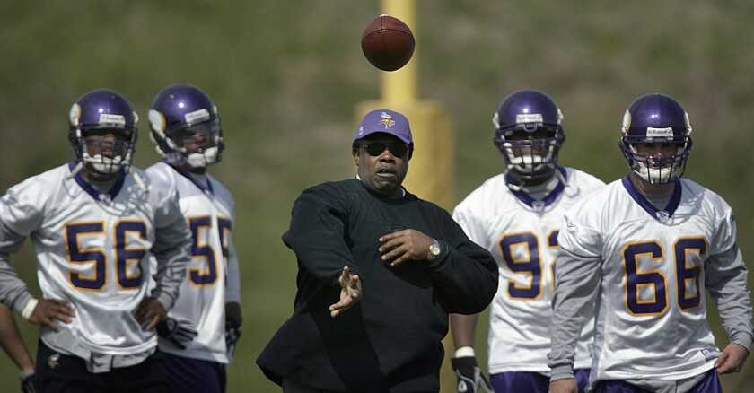 FILE - Minnesota Vikings' defensive coordinator/linebackers Ted Cottrell, middle, runs a drill during the annual mini-camp at the team's practice facility in Eden Prairie, Minn., as Vikings' players, from left, E.J. Henderson, Chris Claiborne, Jeff Mack and Grant Wiley look on, May 7, 2004. Cottrell, who never landed that head coach position despite coordinating some superb defenses for the Bills, Jets, Vikings and Chargers, recalls Paul Tagliabue's passion for equity in hiring; the uneven playing field in which Cottrell and his Black peers were working; and Cottrell's own outspokenness when asked about the inequitable situation. (Jim Gehrz/Star Tribune via AP)