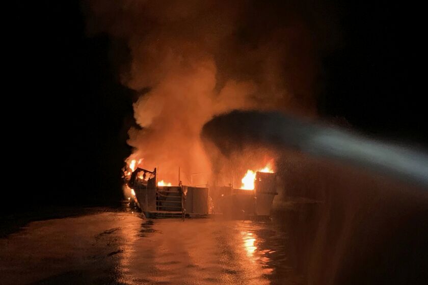 FILE - In this Sept. 2, 2019, file photo, provided by the Ventura County Fire Department, VCFD firefighters respond to a boat fire off the coast of southern California. A crewman injured in the fire that killed 34 people aboard a dive boat off Southern California has sued the boat owner and the company that chartered the vessel. Ryan Sims filed the lawsuit last week in Ventura County Superior Court saying the Conception dive boat was unseaworthy and operated in an unsafe manner. (Ventura County Fire Department via AP, File)