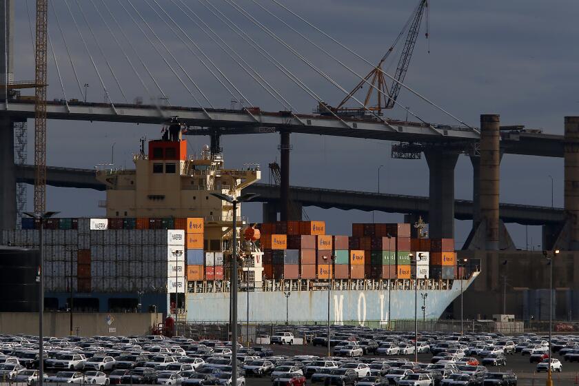 LONG BEACH, CALIF. -MAR. 14, 2020. A cargo container ship owned and operated by the Japanese firm Mitsui OSK Line Ltd. leaves the Port of Long Beach on Saturday, Mar. 14, 2020. Shipping executives say that the global coronavirus pandemic may cause a 20 percent drop in goods arriving in west coast ports like Los Angeles and Long Beach. (Luis Sinco/Los Angeles Times)