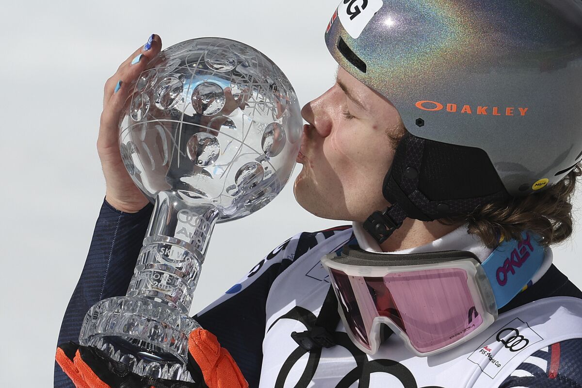 Norway's Lucas Braathen kisses the alpine ski, men's World Cup slalom discipline trophy, in Soldeu, Andorra, Sunday, March 19, 2023. (AP Photo/Alessandro Trovati)