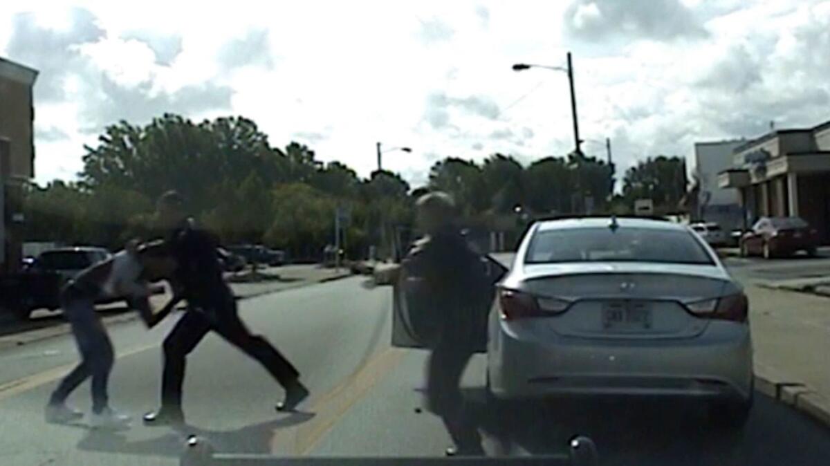 In an image from dashcam video, Euclid, Ohio, police Officer Michael Amiott grabs Richard Hubbard.