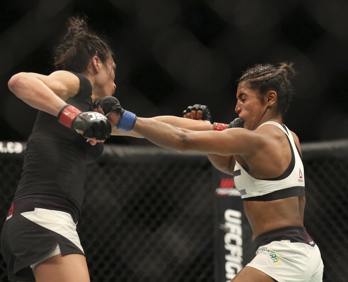 Valerie Letourneau, left, and Viviane Pereira exchange punches during their bout at UFC 206.