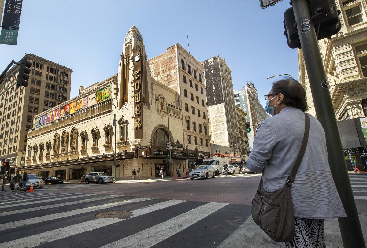 A person looks toward the Apple Tower Theatre in downtown Los Angeles. The store is opening Thursday.