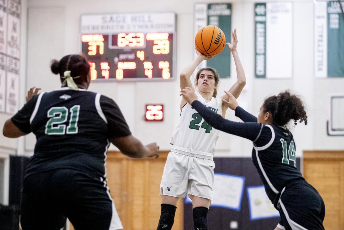 Sage Hill's Isabel Gomez takes a shot against Fairmont Prep's Siyanda Salter, left, and Misty Twyman.