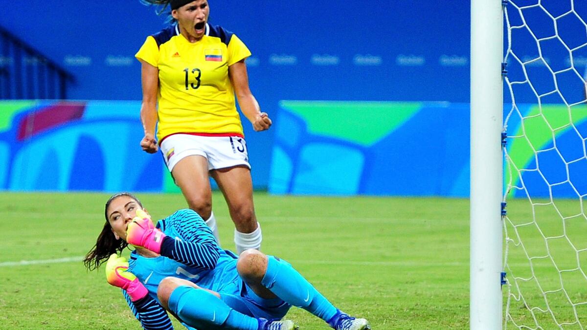 U.S. goalkeeper Hope Solo comes up empty in trying to stop Colombia's Catalina Usme, not pictured, from scoring in the first half Tuesday. Colombia's Angela Clavijo (13) celebrates.