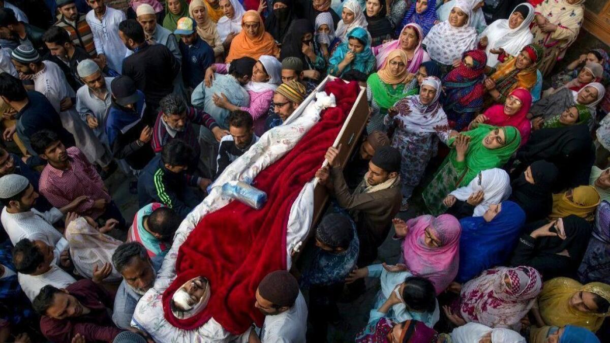 Mourners on Saturday carry the body of Qaiser Amin Bhat, who died after being run over by an Indian paramilitary vehicle the day before.