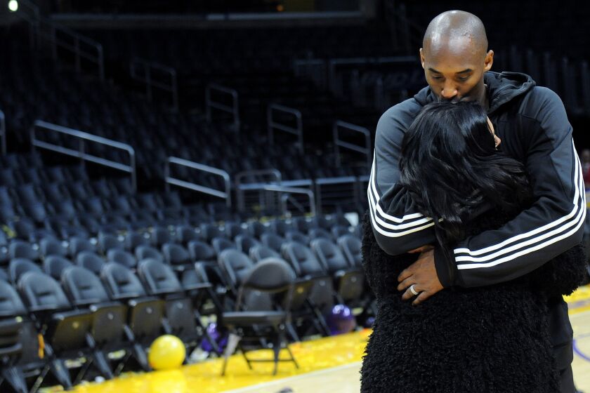 Kobe Bryant kisses his wife Vanessa long after his last game at the Staples Center.