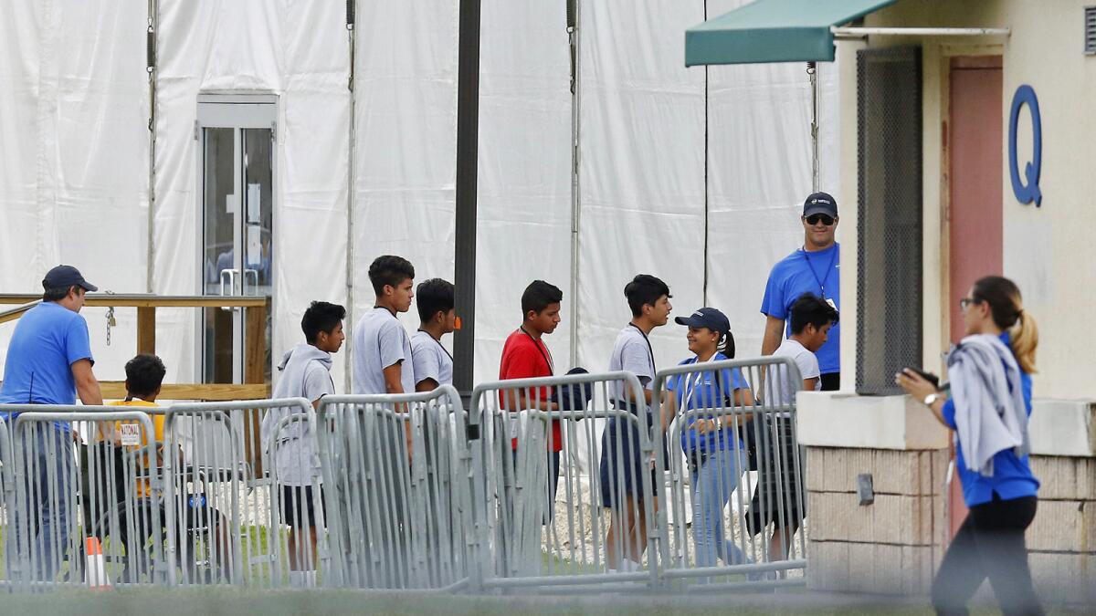 Immigrant children line up outside the Homestead Temporary Shelter for Unaccompanied Children, a former Job Corps site that now houses them in Homestead, Fla.