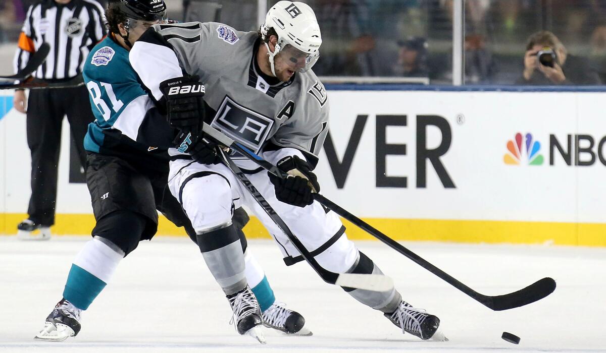 Kings center Anze Kopitar beats Sharks right wing Taylor Kennedy to the puck during their game Saturday night at Levi's Stadium.