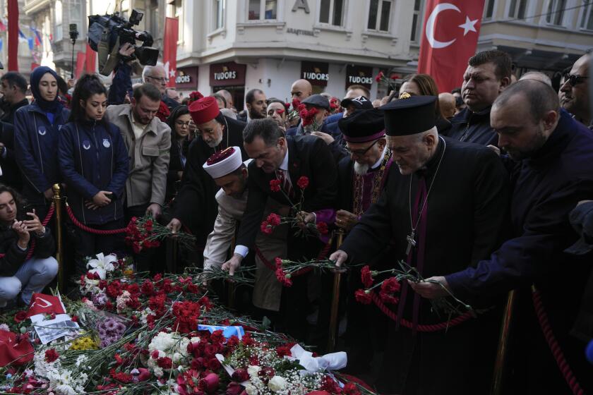 FILE - Representatives of the Turkish communities put flowers over a memorial placed on the spot of Sunday's explosion on Istanbul's popular pedestrian Istiklal Avenue in Istanbul, Turkey, Wednesday, Nov. 16, 2022. Alham Albashir, alleged bomber of a deadly blast killing six and injuring 99, received 7 consecutive life sentences by an Istanbul court on Friday, April 26, 2024, Turkey’s state-run news agency reported. (AP Photo/Khalil Hamra, File)