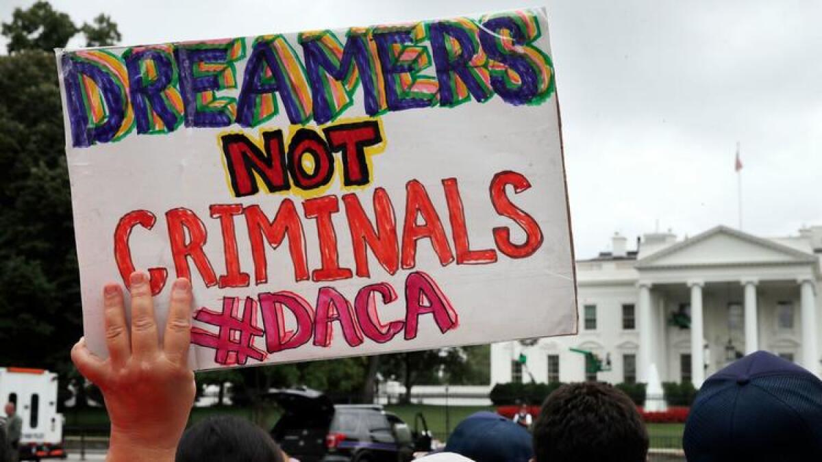 A woman holds a sign in support of the Obama administration program known as Deferred Action for Childhood Arrivals, or DACA, during an immigration reform rally on Aug. 15, 2017, at the White House.
