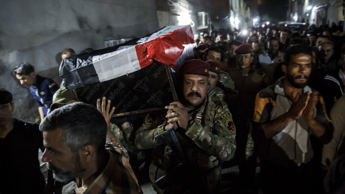 Mourners take part in the funeral for Mustafah, an Iraqi bomb defuser.