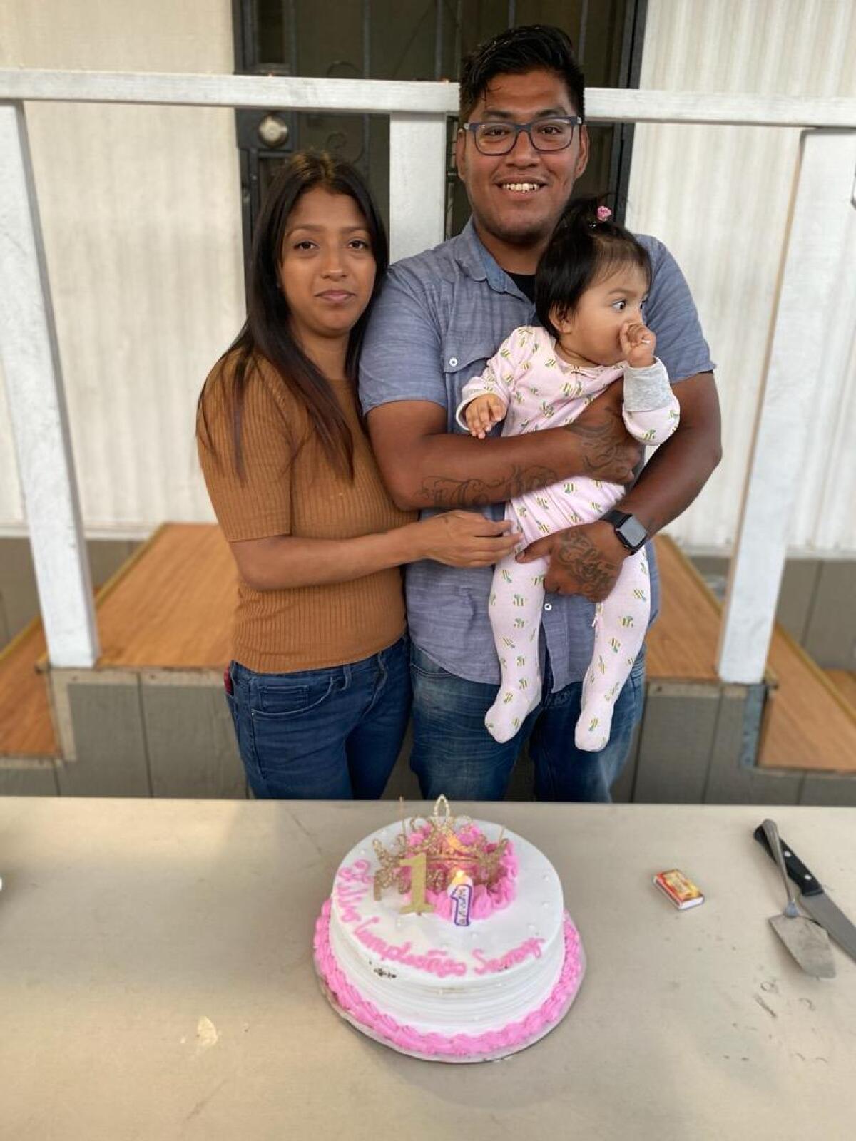 Pictured is Gabriela Andrade, left, and Henry Saldana Meija, right, holding their youngest daughter.