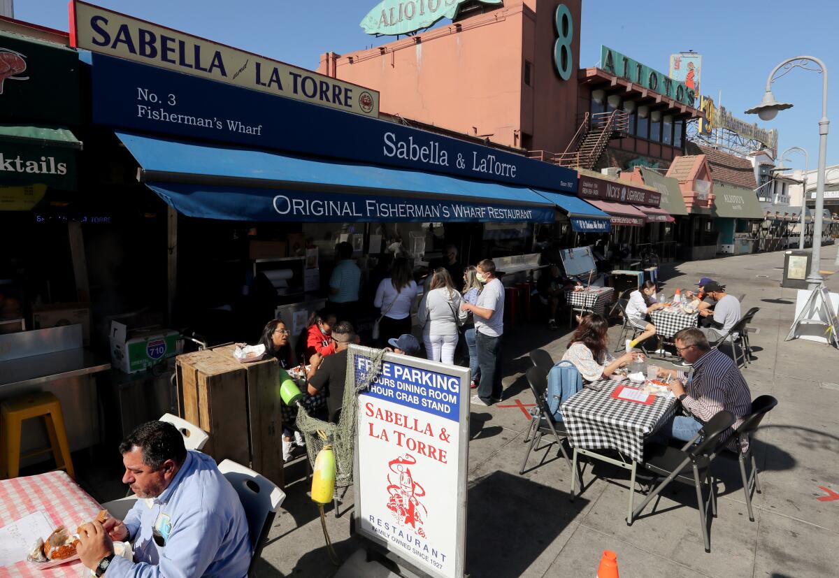 Customers dine in outdoor eating areas at Fishermen's Wharf in San Francisco.