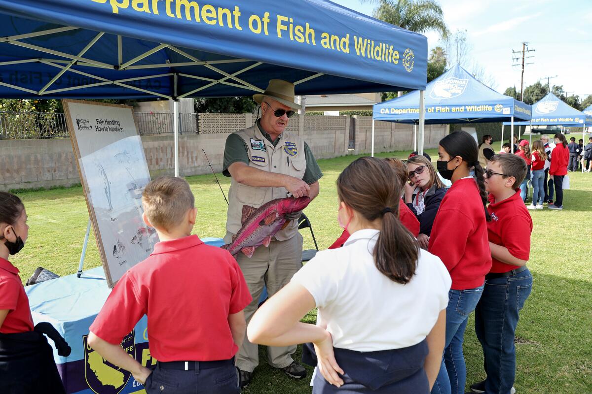 John Ives, a volunteer with the California Department of Fish and Wildlife, gives a demonstration on how to handle a fish.