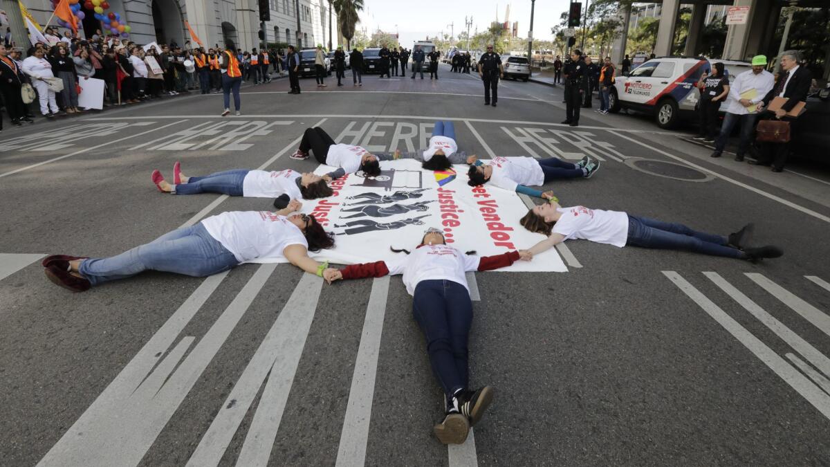Leaders of the L.A. Street Vendor Campaign block Main Street near Los Angeles City Hall on Friday.