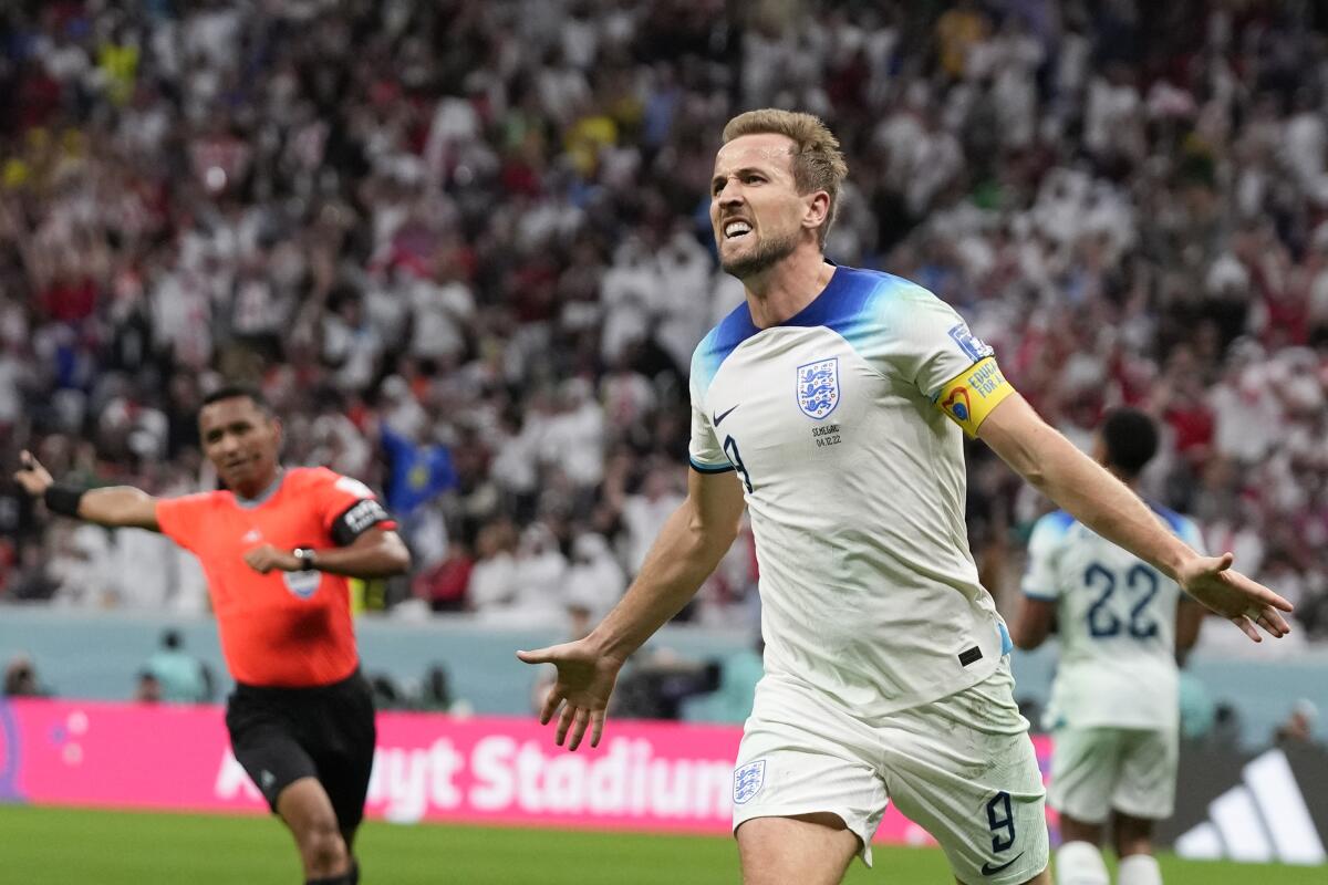 England's Harry Kane celebrates scoring his side's second goal during the World Cup round of 16 soccer match between England and Senegal, at the Al Bayt Stadium in Al Khor, Qatar, Sunday, Dec. 4, 2022. (AP Photo/Frank Augstein)