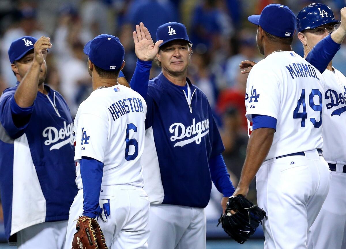 Dodgers Manager Don Mattingly, center, congratulates his players following Sunday's 8-2 win over the Tampa Bay Rays.