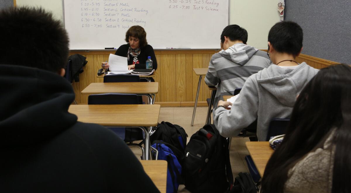 Teacher Svetlana Djananova supervises students taking an ACT college admission exam at HS2 Academy in Arcadia in February.