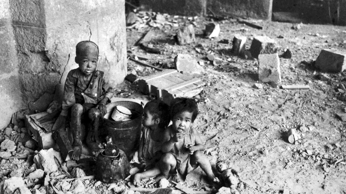 Children in Manila in 1945 in the aftermath of a battle and war crimes.
