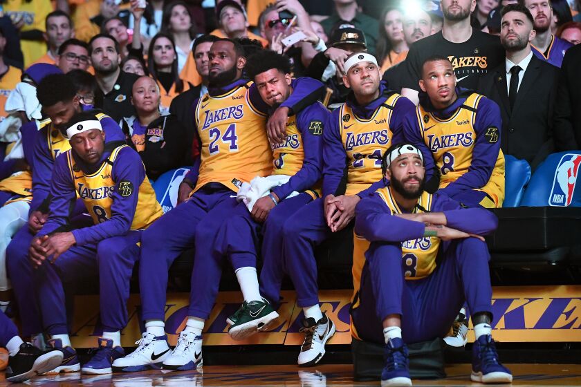 The Lakers hold each other close during a performance by Usher honoring Kobe Bryant on Jan. 31 at Staples Center.