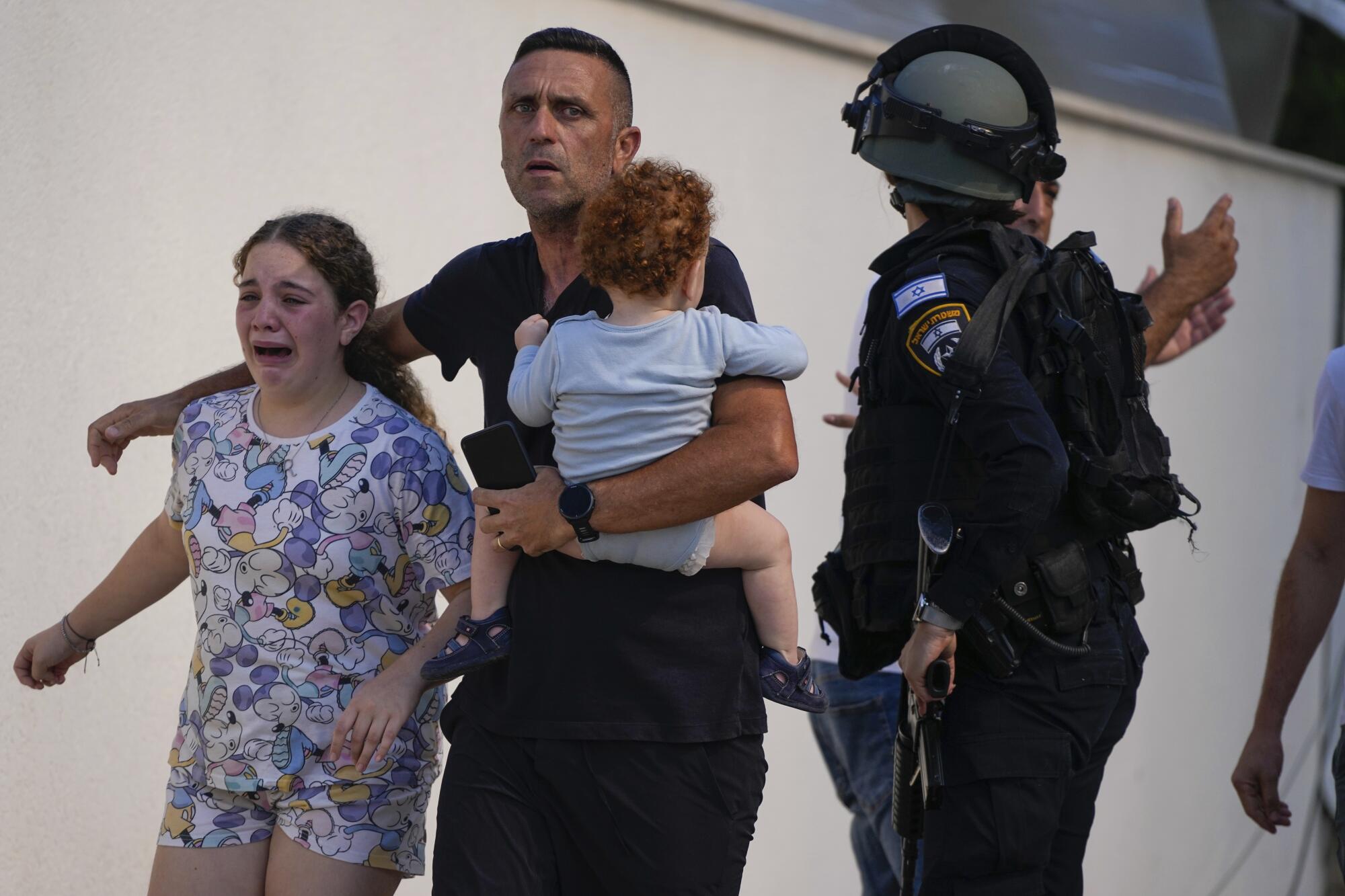 Israeli police officers evacuating a family in Ashkelon, southern Israel