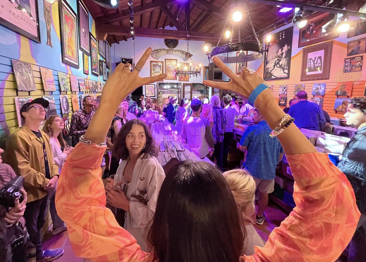 Guests dance to sounds of the ‘60s during a re-opening party of the iconic record store Sound Spectrum in Laguna Beach.