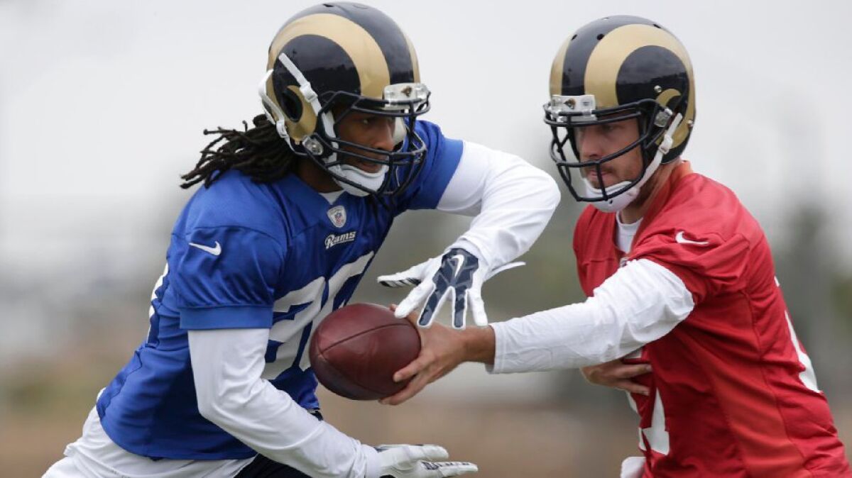 Rams quartertback Case Keenum hands the ball off to running back Todd Gurley during an OTA practice on June 1.