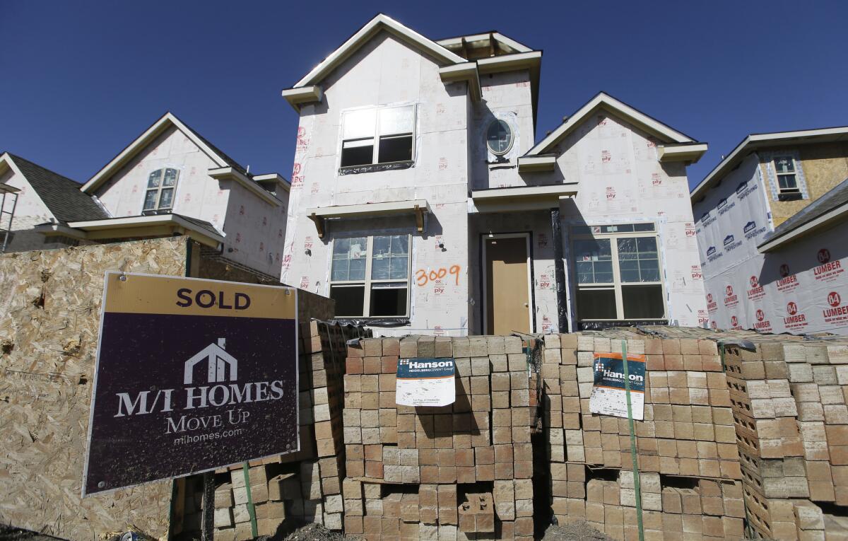 A "Sold" sign sits in front of a house in the final stages of construction in Plano, Texas, on Feb. 2.