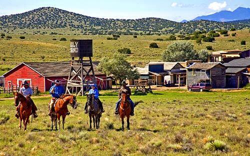 Heading out for a ride from the J.W. Eaves Movie Ranch near Santa Fe are, from left, Marty Miller, Gov. Bill Richardson, reporter Judith Fein and Tim Carroll.