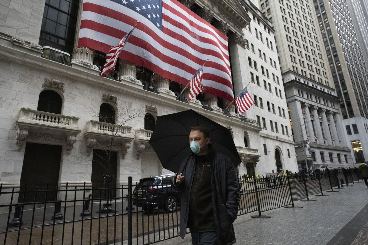 A man walks by the New York Stock Exchange on Tuesday.