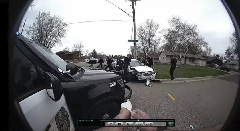 CORRECTS TO BODY CAM OF BROOKLYN CENTER POLICE OFFICER JEFFREY SOMMERS, NOT CHAMPLIN POLICE OFFICER DANIEL IRISH - In this image taken from Brooklyn Center Police Officer Jeffrey Sommers' police body cam video that was played during the trial of former Brooklyn Center police Officer Kim Potter on Thursday, Dec. 9, 2021, in Minneapolis, police approach the car that Daunte Wright was driving after being shot during a traffic stop. Potter, who is white, is charged with first- and second-degree manslaughter in the shooting of Wright, a Black motorist, in the suburb of Brooklyn Center. Potter has said she meant to use her Taser – but grabbed her handgun instead – after Wright tried to drive away as officers were trying to arrest him. (Court TV, via AP, Pool)