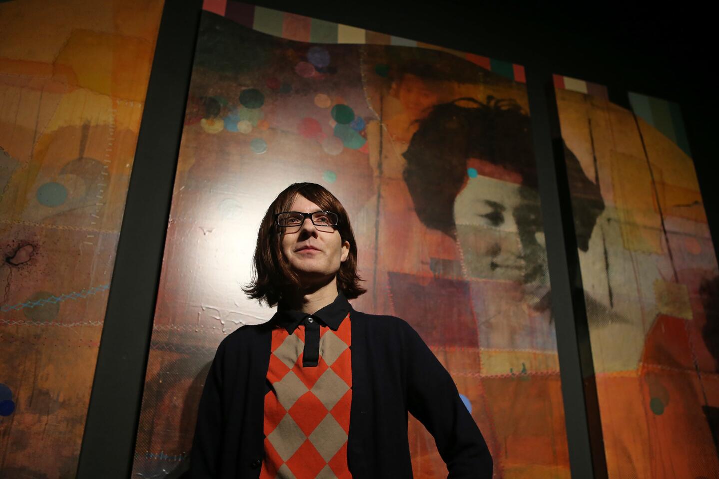 Artist Geoff Mitchell stands in front of "The Emperor's Night Garden," a piece in his "Ghost Stories and Fairy Tales" exhibit at the Muzeo Museum and Cultural Center in Anaheim.