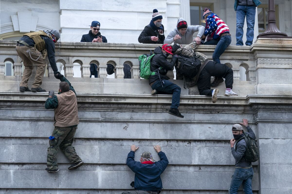 FILE - Insurrections loyal to President Donald Trump climb the west wall of the the U.S. Capitol, Jan. 6, 2021, in Washington. For many rioters who stormed the U.S. Capitol, self-incriminating messages, photos and videos that they broadcast on social media before, during and after the Jan. 6 insurrection are influencing even the sentences in their criminal cases. Among the biggest takeaways from the Justice Department’s prosecution of the Jan. 6 insurrection is how large a role social media has played, with much of the most damning evidence coming from rioters own words and videos. (AP Photo/Jose Luis Magana, File)