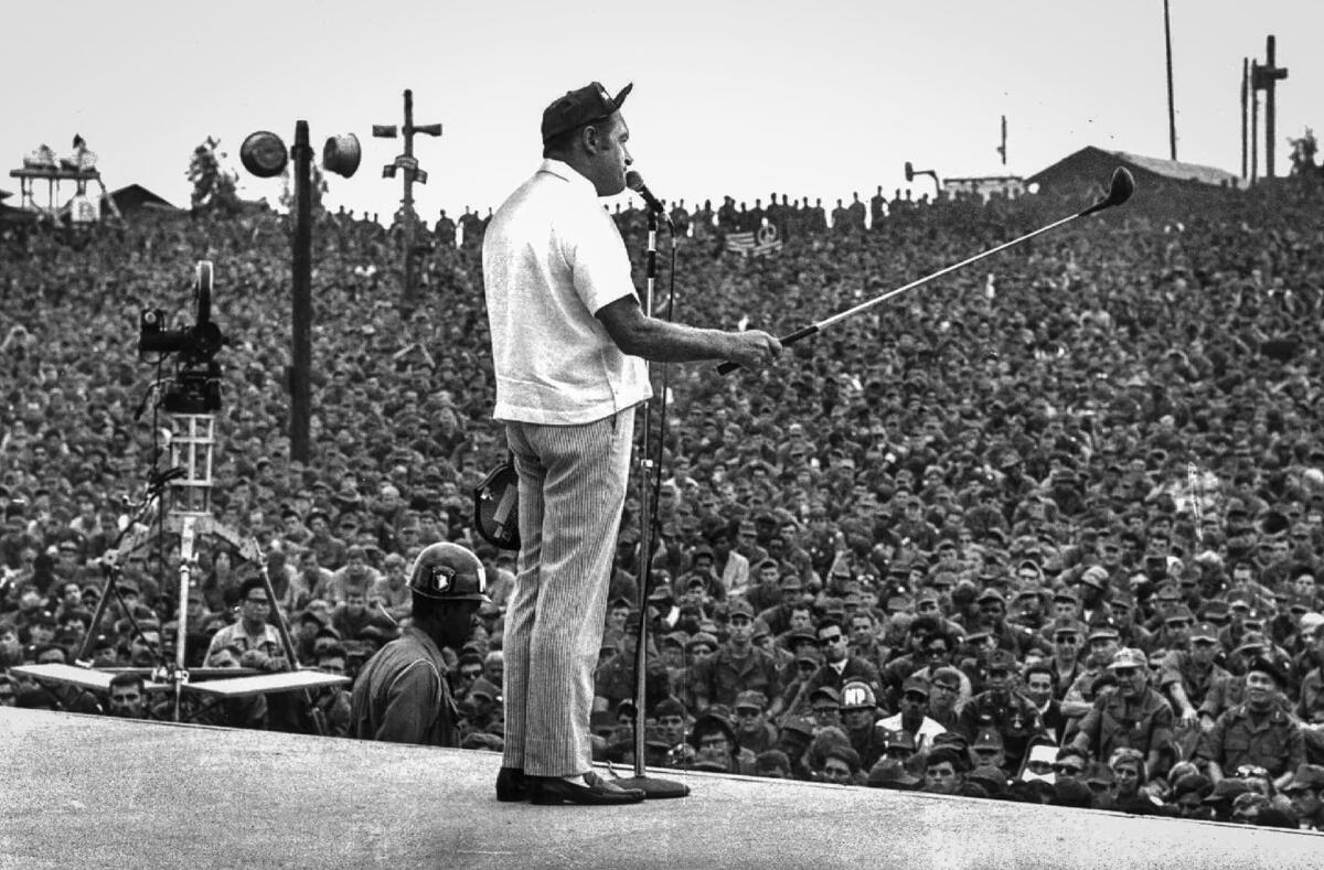 December 1969: Bob Hope cracks jokes in front of an audience of thousands of GIs massed in an open-air theater in Cu Chi, 20 miles northeast of Saigon, during a Christmas tour of Vietnam.