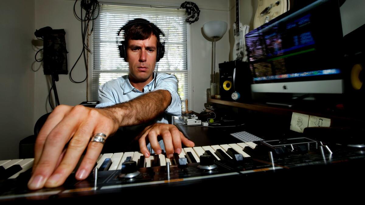 Composer and musician Nick Thorburn plays a synthesizer inside his home studio in Los Angeles on July 28, 2017. Thorburn wrote the theme music for the podcast Serial (seasons one and two).