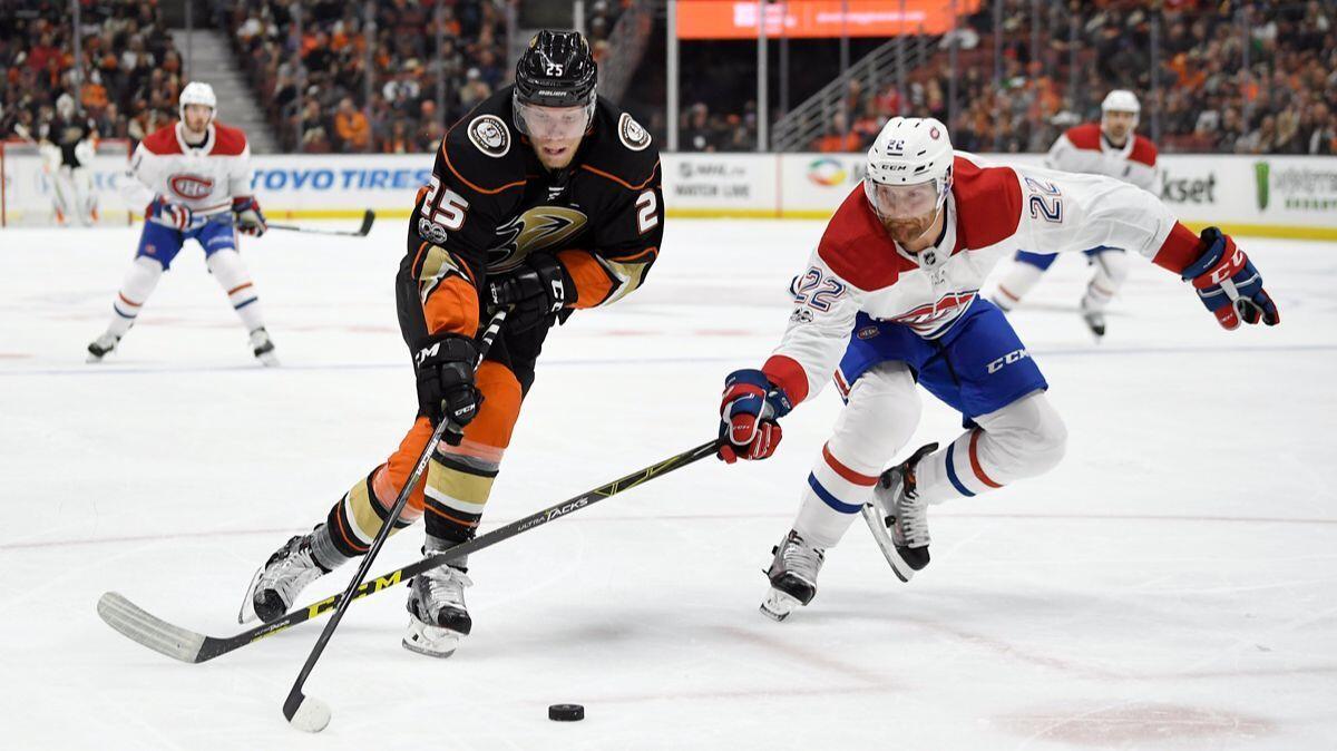 Ducks right wing Ondrej Kase, left, moves the puck as Montreal Canadiens defenseman Karl Alzner reaches in during the second period on Friday.