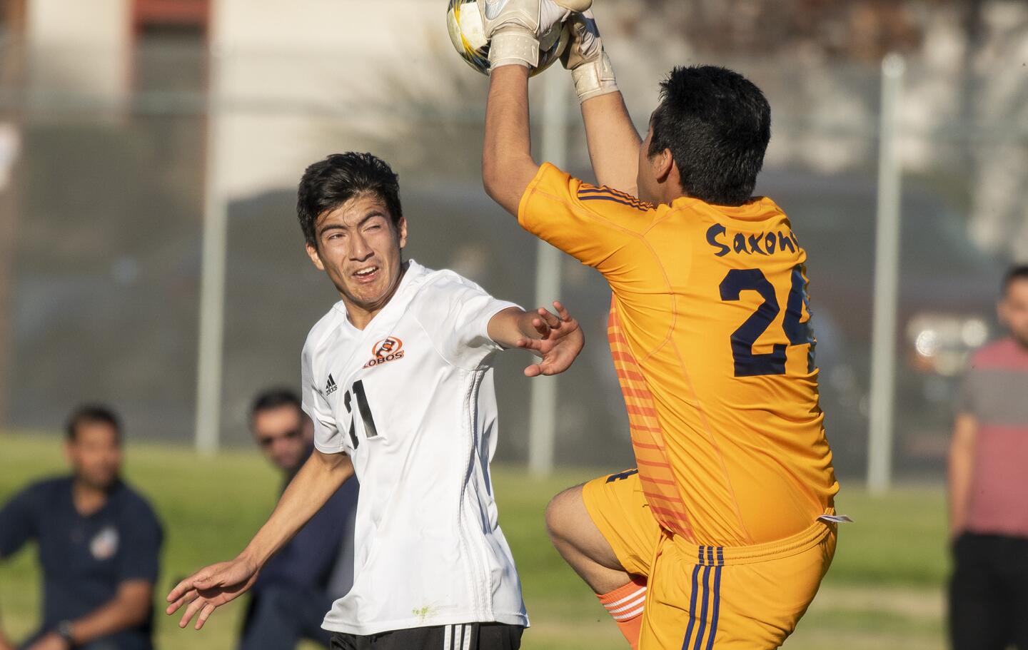 Los Amigos' Francisco Lopez goes up for a ball against Loara's goal keeper Luis Garcia during a Garden Grove League match on Friday, January 25.