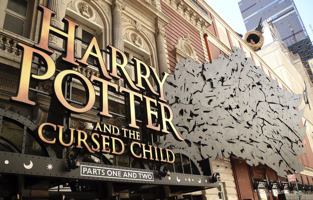 A sign for "Harry Potter and the Cursed Child" outside a theater