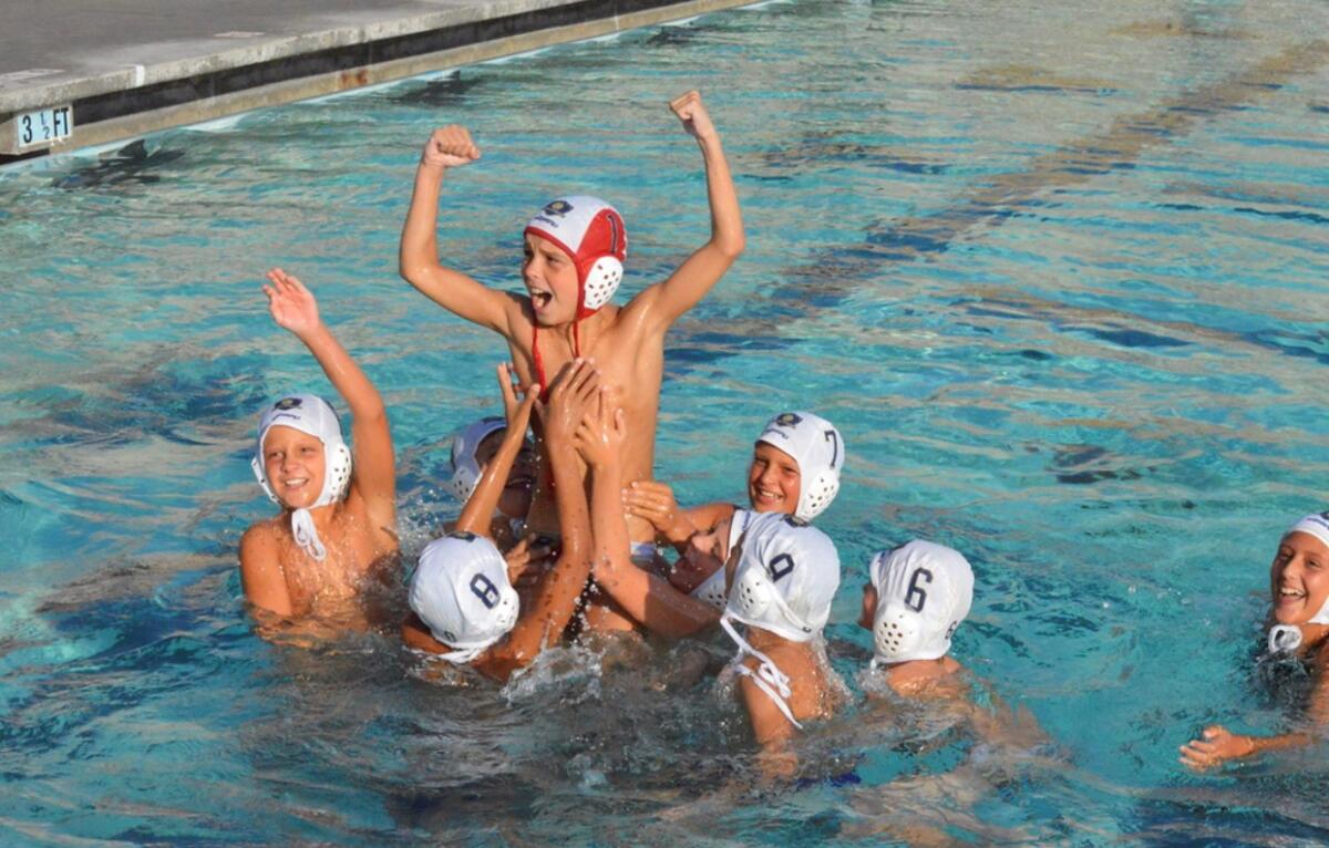 The La Jolla United 10U coed water polo team celebrates a victory during the USA Water Polo Junior Olympics.