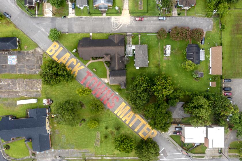 An aerial view of Link Road in Independence Heights in Houston that features a mural that reads "Black Towns Matter."
